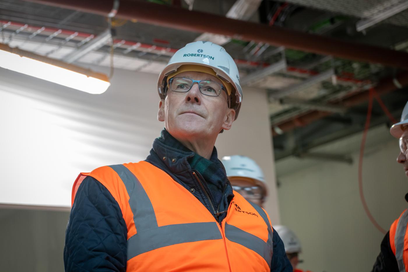 John Swinney in Robertson Construction PPE on-site at Perth High School