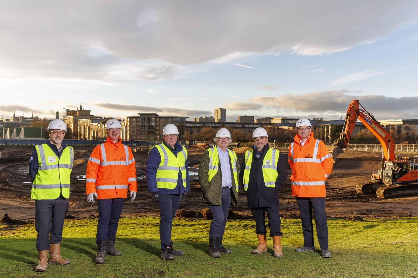  Six people standing on site where the £50m Aberdeen Beachfront transformation will take place, delivered by Robertson Construction Group
