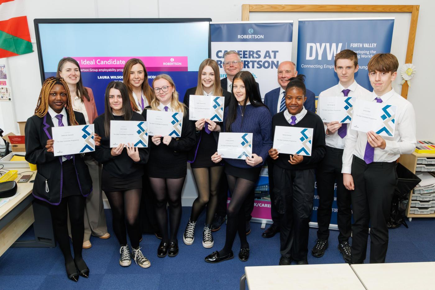 School pupils holding certificates from Robertson Group's Ideal Candidate Programme