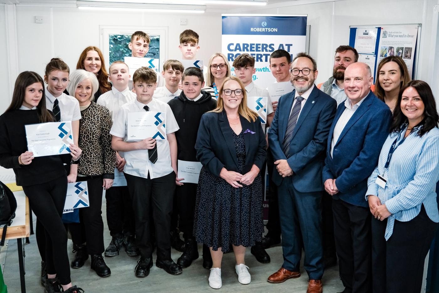 School pupils holding certificates from Robertson Group's Ideal Candidate Programme