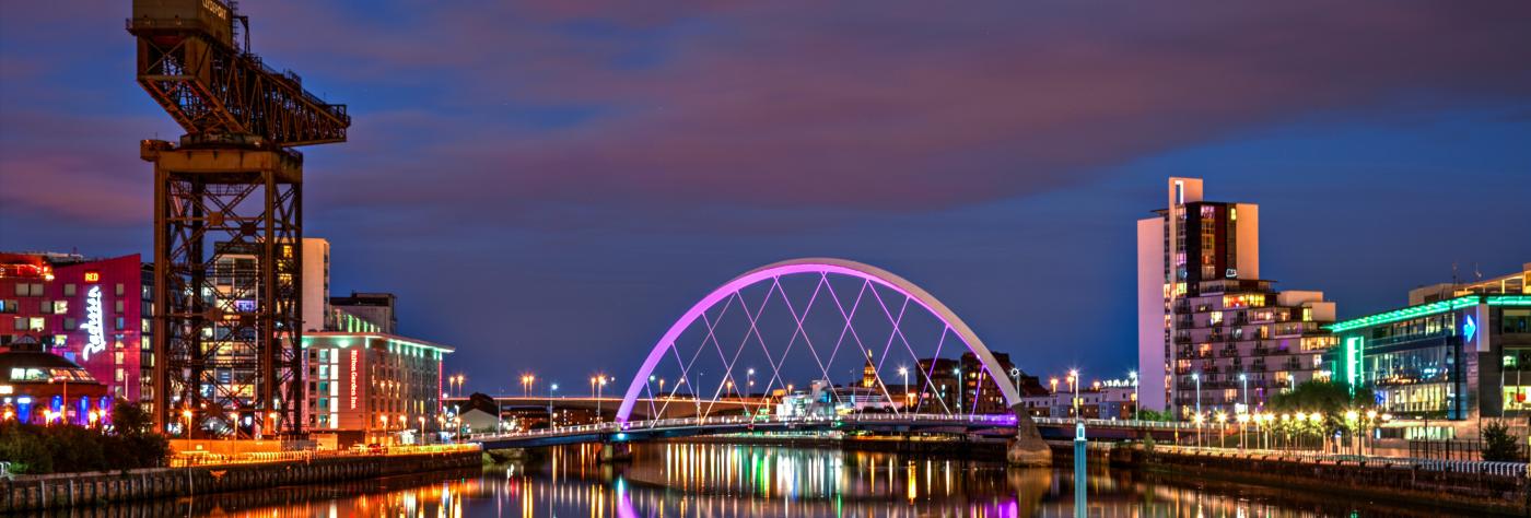 Glasgow city skyline from the river Clyde at night