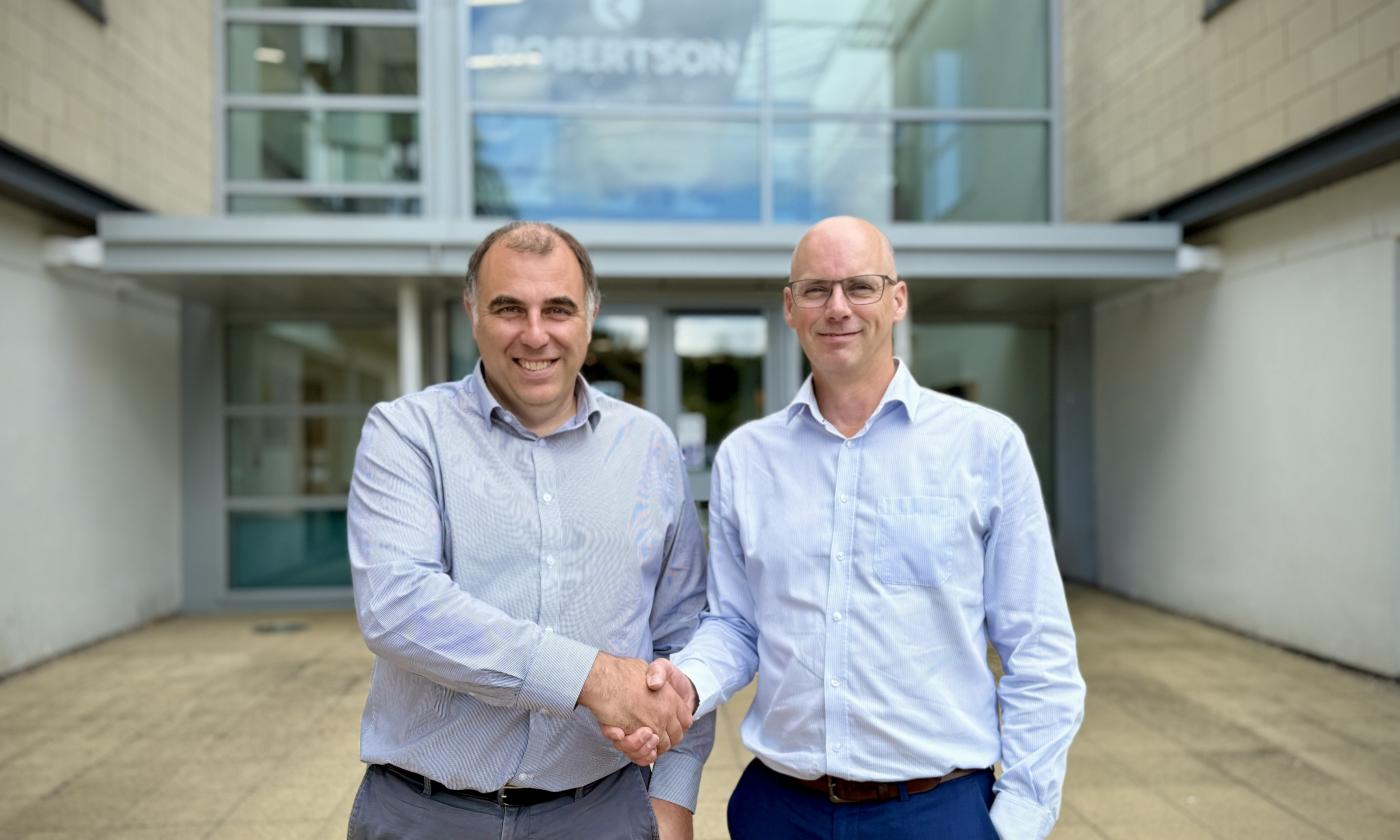 Two men shaking hands outside Robertson Group Head Office