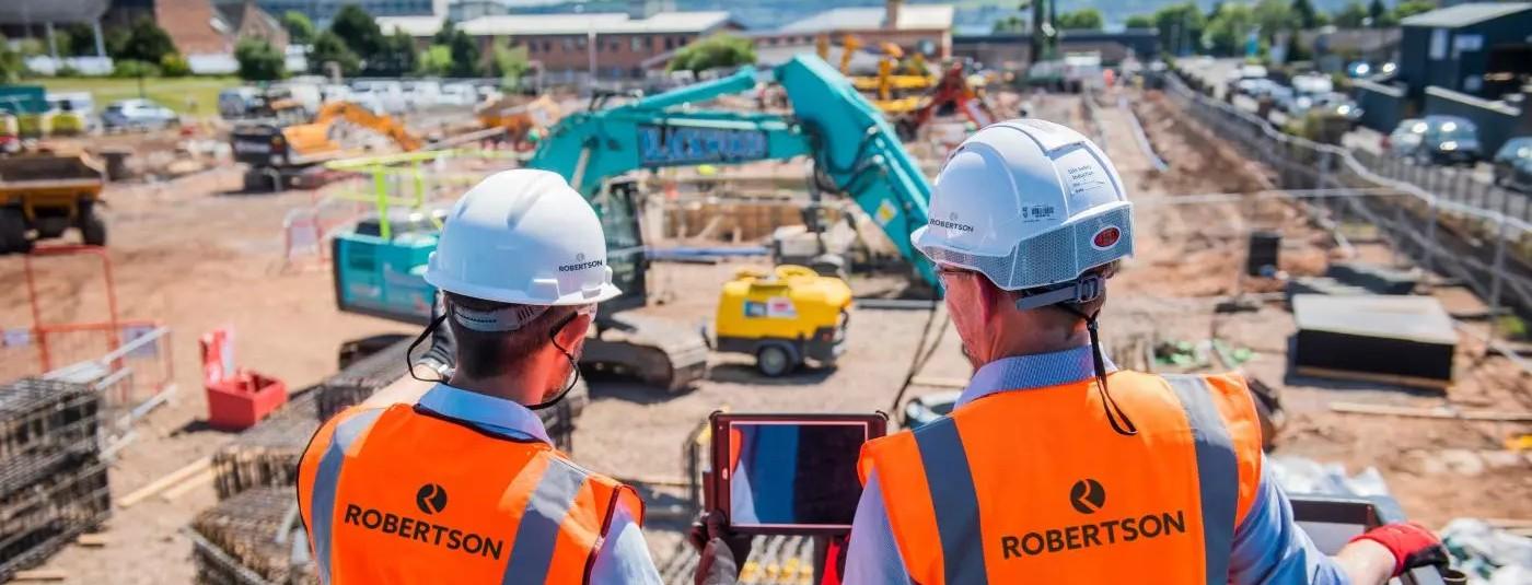 Construction site managers looking at groundworks supply chain delivering services