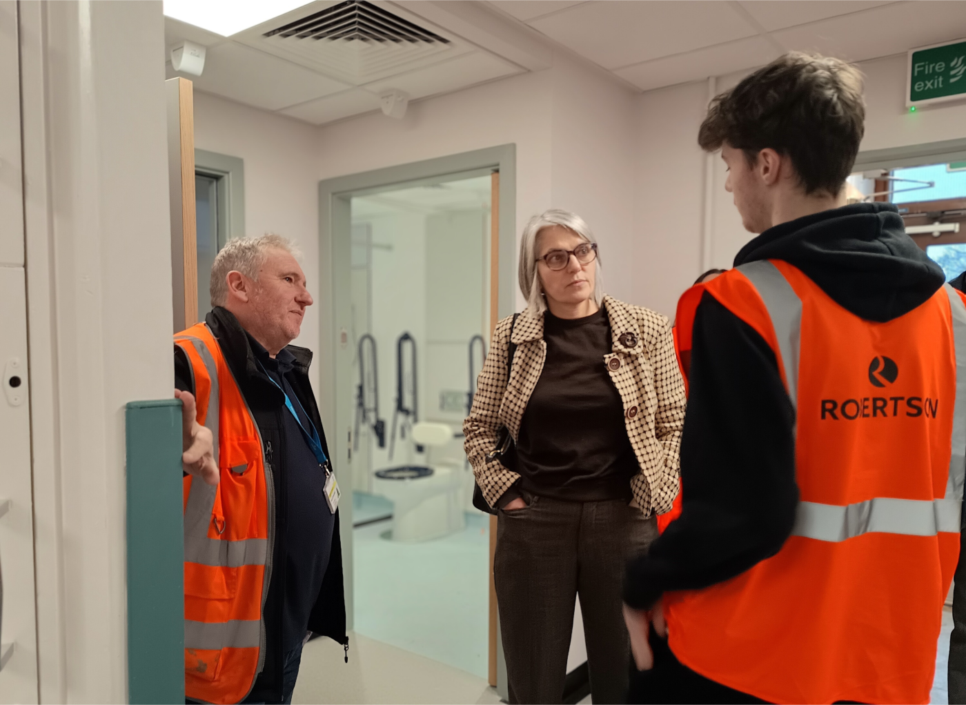 Bradford College student speaking with an MP and senior site manager about the work he's doing at the Robertson Construction site at Airedale General Hospital