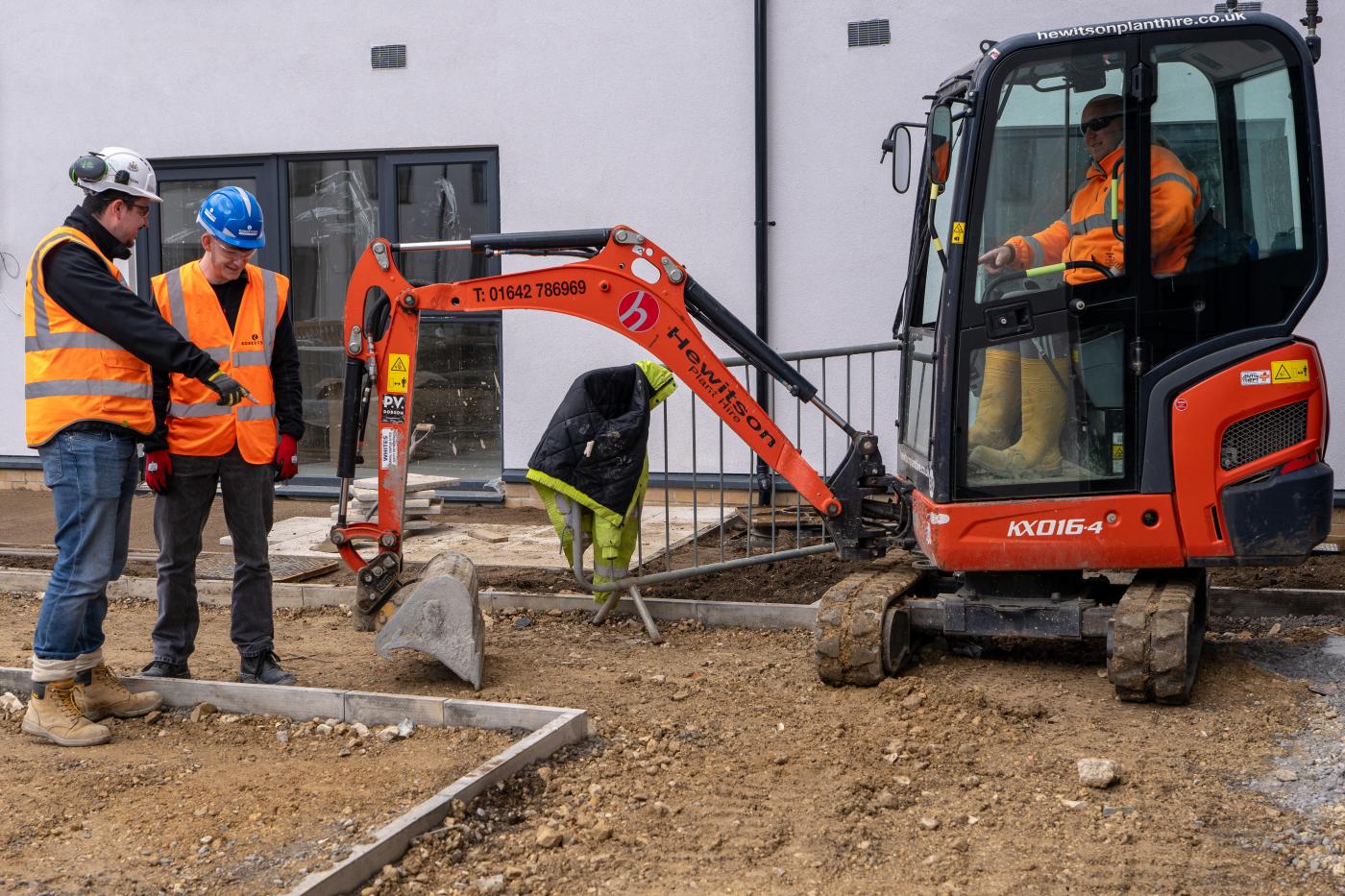Image shows Robertson site manager Kieran Pemberton (far left), and Damien Lee (far right) from Hewitson Limited with Jack Grainger (middle), who completed a work placement at the Hebburn development with Robertson before securing a position with Hewitson as a trainee site manager.
