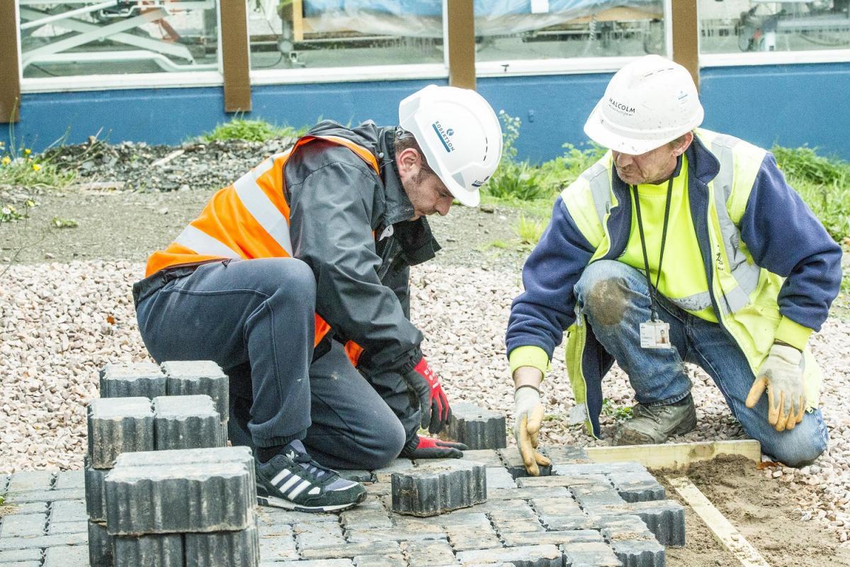  A JCP client tries his hand on site, assisted by a Robertson employee